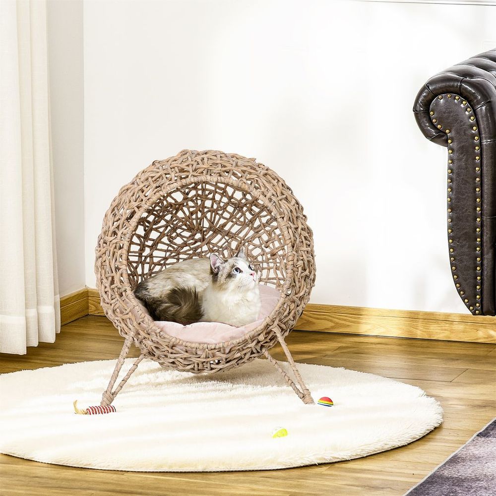 cat relaxing in ball shaped cat bed
