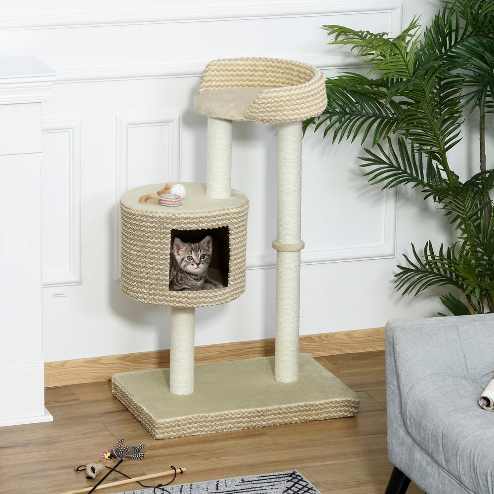 Cat relaxing in a cat bed of a beige cat tree with scratching posts